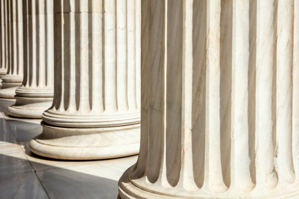 Pillar column white marble. Justice building, court entrance colonnade, close up view